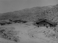 Buildings and homes scattered in the desert in Johnnie, Nevada, Monochrome  Buildings and homes at Johnnie, sometime during 1940's or 1950's, courtesy UNLV