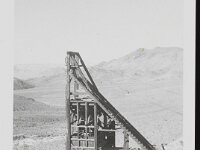 Head frame of Johnnie Mine. The structure stands tall with cables attached to the top, trailing out of the image.  Courtesy UNLV