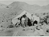 UNLV Men pose in front of a tent in the desert in Wahmonie, Nevada  Men posing in front of a tent. Courtesy UNLV