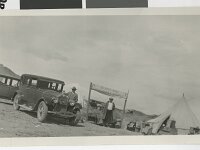 UNLV Two men stand near automobiles and the sign for Gilbert Bros. Groceries & Supplies  This picture of the Gilbert Brothers Grocery store makes me dizzy. Courtesy UNLV